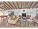 Spacious living room boasts a fireplace, exposed beam ceiling, tile flooring, and comfortable seating area at 6701 N Scottsdale Rd # 23, Scottsdale, AZ 85250