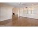 Bright living room features a fireplace, hardwood floors, built-in shelves, and arched doorway at 6701 N Scottsdale Rd # 23, Scottsdale, AZ 85250