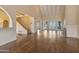 Bright, open-concept living room with hardwood floors and views of the backyard and staircase at 6701 N Scottsdale Rd # 23, Scottsdale, AZ 85250