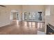 Sunlit living room featuring hardwood floors, a fireplace, and access to outdoor patio at 6701 N Scottsdale Rd # 23, Scottsdale, AZ 85250