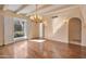 Bright formal living room with hardwood floors, chandelier, and access to outdoor courtyard at 6701 N Scottsdale Rd # 23, Scottsdale, AZ 85250