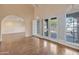 Living room with arched entryways, French doors, shuttered windows, and hardwood floors at 6701 N Scottsdale Rd # 23, Scottsdale, AZ 85250