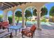 Inviting outdoor patio area with comfortable seating, arched columns, and views of the pool at 6701 N Scottsdale Rd # 23, Scottsdale, AZ 85250