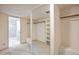 Spacious walk-in closet with ample shelving and storage space, located near bathroom at 6701 N Scottsdale Rd # 23, Scottsdale, AZ 85250
