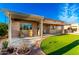 Covered back patio that features a putting green, patio furniture, and desert landscaping at 6777 S Four Peaks Way, Chandler, AZ 85249