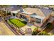 Aerial view of backyard showing a lush putting green, covered patio, outdoor bar and desert landscape at 6777 S Four Peaks Way, Chandler, AZ 85249