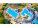 Aerial view of the community pool with mature palm trees and lounge chairs in a resort style setting at 6777 S Four Peaks Way, Chandler, AZ 85249