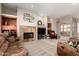 Cozy living room with a fireplace, built-in shelving, and comfortable seating at 6777 S Four Peaks Way, Chandler, AZ 85249