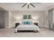 This carpeted main bedroom features a ceiling fan, neutral walls, and matching nightstands with lamps at 6844 W Mazatzal Dr, Peoria, AZ 85383