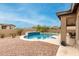 Custom pool with raised wall, surrounding landscaping, desert views, and patio at 6844 W Mazatzal Dr, Peoria, AZ 85383