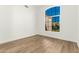 Light-filled bedroom with wood-look flooring and a large window at 7307 E Laguna Azul Ave, Mesa, AZ 85209