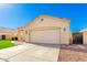 Front exterior with a lush lawn, large driveway, and a two-car garage at 7307 E Laguna Azul Ave, Mesa, AZ 85209