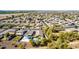 Scenic aerial view of neighborhood homes with desert landscaping, community parks, and tree-lined streets at 7341 W Magdalena Ln, Laveen, AZ 85339