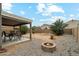 This backyard features a fire pit, desert landscaping, and an outdoor dining area at 743 E Dragon Springs Dr, Casa Grande, AZ 85122