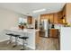 Well-lit kitchen featuring stainless steel appliances, counter seating, and wood-look tile floors at 743 E Dragon Springs Dr, Casa Grande, AZ 85122