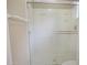 Clean bathroom featuring an updated shower with glass doors and convenient towel hooks at 8613 S 49Th Dr, Laveen, AZ 85339