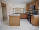 Well-equipped kitchen featuring an island, tile floors, and plenty of counter space at 8613 S 49Th Dr, Laveen, AZ 85339