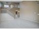 Open-concept living room with tile floors, staircase, and high ceilings at 8613 S 49Th Dr, Laveen, AZ 85339