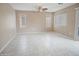 Spacious living room with tile flooring, a ceiling fan, and natural light from the windows at 8613 S 49Th Dr, Laveen, AZ 85339