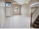 Inviting living room with large windows, tile flooring, and staircase at 8613 S 49Th Dr, Laveen, AZ 85339