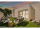Inviting backyard features modern furniture, lush artificial grass, and a charming patio area, perfect for outdoor entertaining at 930 S Dobson Rd # 41, Mesa, AZ 85202