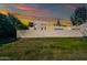 Exterior view of a well-maintained house with a green lawn and a privacy wall for added seclusion at 930 S Dobson Rd # 41, Mesa, AZ 85202