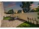 Relaxing backyard featuring a patio set, green grass, and a privacy wall, perfect for outdoor entertaining at 930 S Dobson Rd # 41, Mesa, AZ 85202