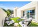 Inviting backyard features modern furniture, lush artificial grass, and a charming patio area, perfect for outdoor entertaining at 930 S Dobson Rd # 41, Mesa, AZ 85202