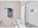 Bright bathroom featuring a shower with white tile and black, white, and gray mosaic flooring and neutral-toned walls at 930 S Dobson Rd # 41, Mesa, AZ 85202