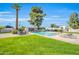 Inviting community pool surrounded by lush greenery, lounge chairs, and manicured lawns under a bright blue sky at 930 S Dobson Rd # 41, Mesa, AZ 85202