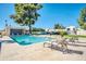 Well-maintained community pool featuring lounge chairs and lush greenery under a sunny, blue sky at 930 S Dobson Rd # 41, Mesa, AZ 85202