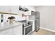 Bright kitchen featuring white cabinets, stainless steel appliances, and modern countertops at 930 S Dobson Rd # 41, Mesa, AZ 85202
