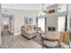 Bright living room features a modern fireplace, neutral decor, and wood-look tile floors at 930 S Dobson Rd # 41, Mesa, AZ 85202