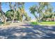 Quiet community street featuring mature trees and manicured lawns, creating a serene and inviting neighborhood atmosphere at 930 S Dobson Rd # 41, Mesa, AZ 85202