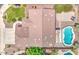 Aerial view of house featuring a private pool, lush green landscaping, and brick pavers at 9426 E Los Lagos Vista Ave, Mesa, AZ 85209