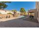Spacious backyard with a covered patio, BBQ, brick pavers, gravel and a fenced pool at 9426 E Los Lagos Vista Ave, Mesa, AZ 85209