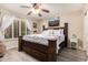 Bedroom featuring wood frame bed with drawer storage, ceiling fan, and shuttered windows at 9426 E Los Lagos Vista Ave, Mesa, AZ 85209