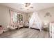 Bright ' bedroom features a crib with canopy, and a ceiling fan at 9426 E Los Lagos Vista Ave, Mesa, AZ 85209