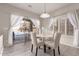 Bright dining area featuring a round table, stylish chairs, and sliding glass doors to the backyard pool at 9426 E Los Lagos Vista Ave, Mesa, AZ 85209