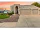 Charming two-story home with a spacious driveway and a well-maintained lawn showcasing desert landscaping at 9426 E Los Lagos Vista Ave, Mesa, AZ 85209
