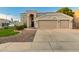 Inviting two-story home with a double garage, manicured lawn, and desert landscaping offering a welcoming entrance at 9426 E Los Lagos Vista Ave, Mesa, AZ 85209