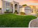 Beautiful two-story home with a well-manicured lawn, mature trees, and arched entry, creating an inviting curb appeal at 9426 E Los Lagos Vista Ave, Mesa, AZ 85209