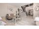Open-concept living area with marble floors, neutral decor, and a view of the staircase leading to the upper level at 9426 E Los Lagos Vista Ave, Mesa, AZ 85209