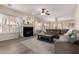 Spacious living room with a cozy fireplace, plush sectional sofa, and stylish decor at 9426 E Los Lagos Vista Ave, Mesa, AZ 85209