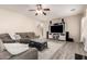 Inviting living room showcases a large TV, sectional sofa, and neutral tones at 9426 E Los Lagos Vista Ave, Mesa, AZ 85209