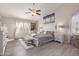 Bright main bedroom features wood-look floors, white furniture, ceiling fan, and plush decor at 9426 E Los Lagos Vista Ave, Mesa, AZ 85209