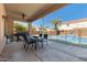 Covered patio with ceiling fan, lights, an outdoor kitchen with BBQ and a dining table at 9426 E Los Lagos Vista Ave, Mesa, AZ 85209