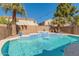 Backyard pool featuring a waterfall, landscaping, string lights and palm trees at 9426 E Los Lagos Vista Ave, Mesa, AZ 85209
