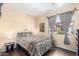Light-filled bedroom features a plush bed and a view to the neighborhood at 9537 E Flint Dr, Gold Canyon, AZ 85118