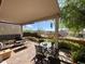 Inviting covered patio with comfortable seating area and views of desert landscape at 9537 E Flint Dr, Gold Canyon, AZ 85118